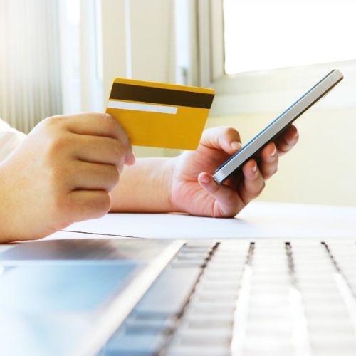 An Individual Holding a Credit Card, Exploring the Best Payment Processor for Small Business.