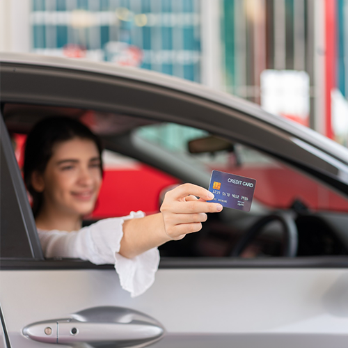 A Woman in a Car Holding a Card, Ready to Buy Car Using Credit Card.