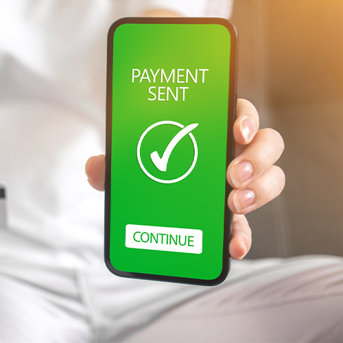 A Woman Holds Up a Smartphone with a Payment Sent Sign on It. Showcasing a Convenient Way to Send Money Online.