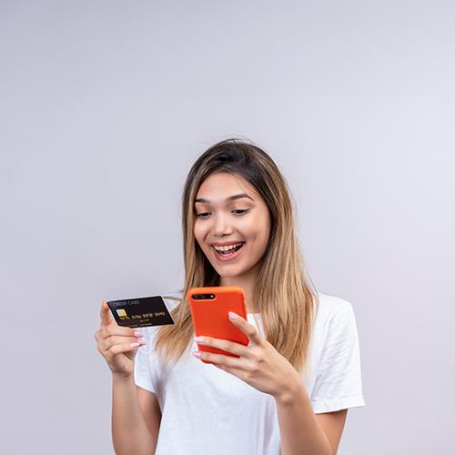 A Young Woman Seamlessly Accept Payment by Credit Card Using Her Smartphone
