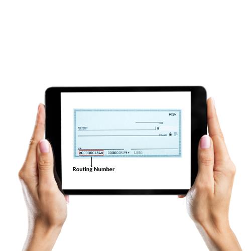 A Person Holding an iPad with a Check Deposited on It, Displaying the Check Routing Number