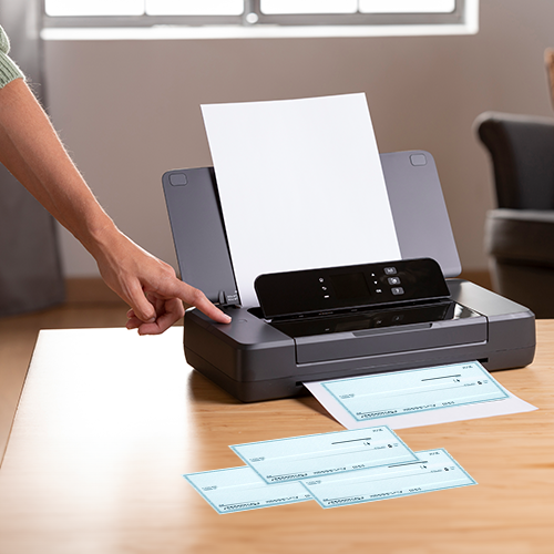 A Person Uses a Printer to Print Business Checks Online.