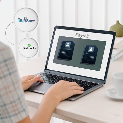 Using a Laptop, a Woman Uses QuickBooks Payroll Services Offered by Zil Money.