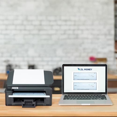 Laptop and Check Printer Online Setup on a Desk, Indicating a Modern Financial Transaction Processing Workspace.