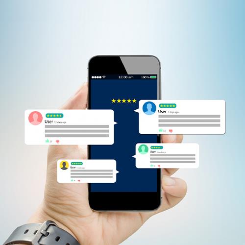 A Hand Holding a Smartphone Displaying a Customer Rating App, Involved in a Group Text Message Conversation.