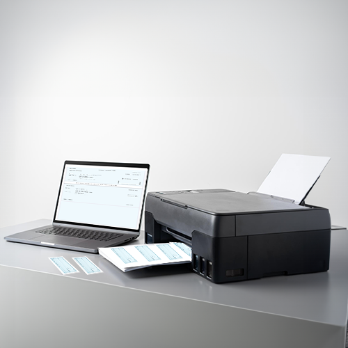 Print Personal Checks from Home Are Printed from a Printer and Laptop on a Table