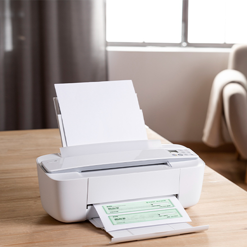 A Printer Prints Checks on a Table Using the Free Check Generator