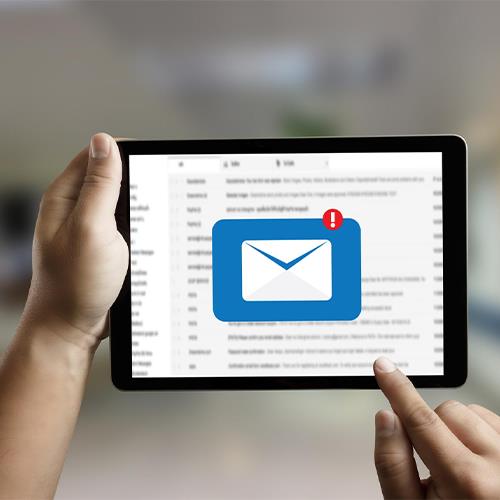 A Person Holding a Tablet with an Enlarged Email Notification Icon, Related to Send Checks By Mail.
