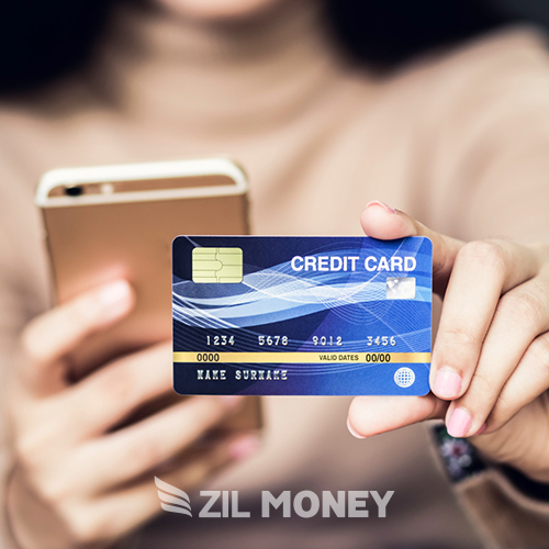 A Person Holding a Smartphone in One Hand and Displaying a Credit Card, Facilitating Small Steps, Big Impact Credit Card Processing for Small Businesses.