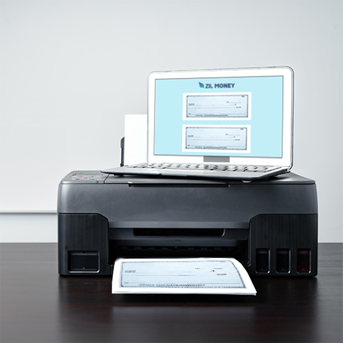 A Modern Black Check Printer on a Desk Prints a Check, with the Label Displayed on the Monitor Screen Visible Behind the Check