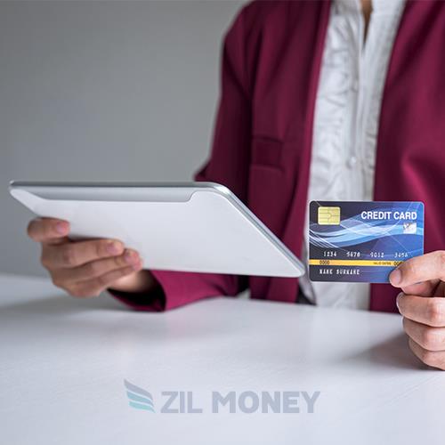 A Professional Showcasing Credit Card Payments For Small Businesses with a Tablet and Credit Card