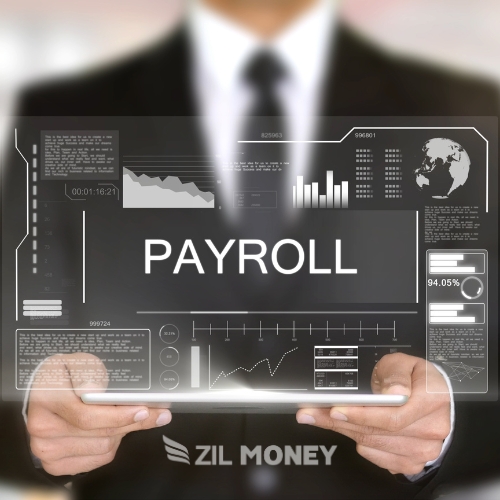 Business Professional Holding a Transparent Futuristic Screen Displaying Payroll Data. He Is Managing Payroll
