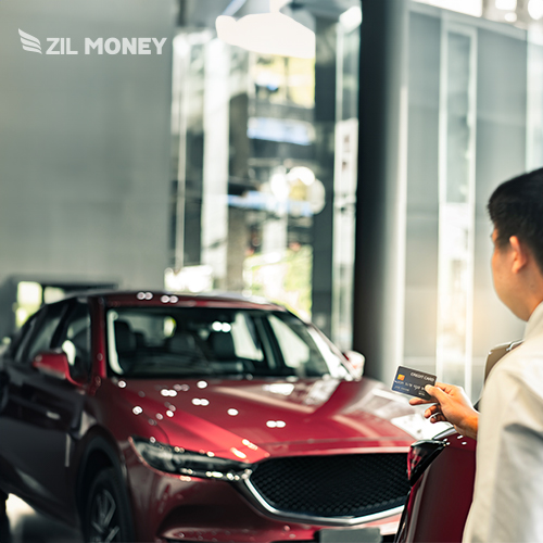 A Man Is in Front of a Car. He Is Ready to Pay Car Payment with Credit Card