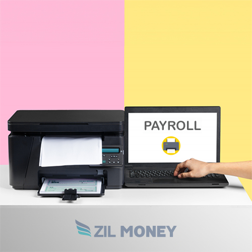 Laptop and Printer Are Arranged on a Desk. The Printer Prints Payroll Checks