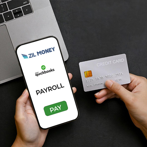A Person Holds a Credit Card and Smartphone Displaying Payroll by Credit Card QuickBooks For Fast and Secure Payments