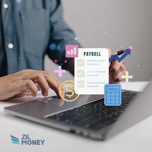 A Person Is Working on a Laptop. Digital Icons Above the Keyboard Signify Payroll Management Services