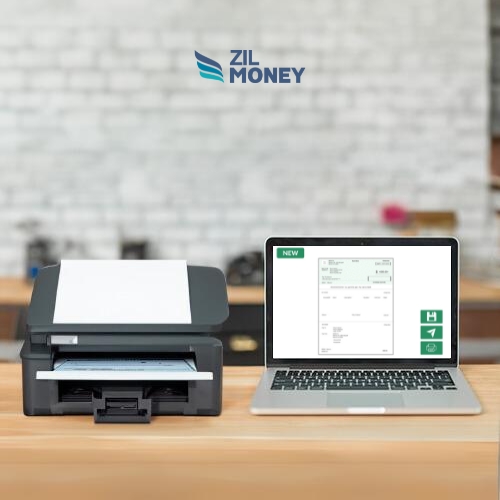 A Laptop and a Printer Are on the Table. The Laptop Shows the Printable Business Checks Template