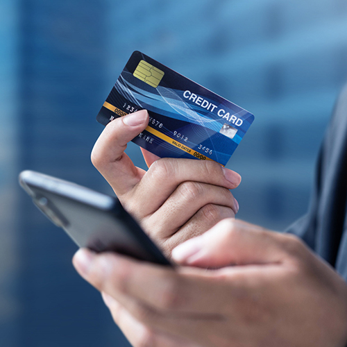 A Hand Holding a Credit Card And Smartphone, Smart Solutions Pay Vendor with Credit Card