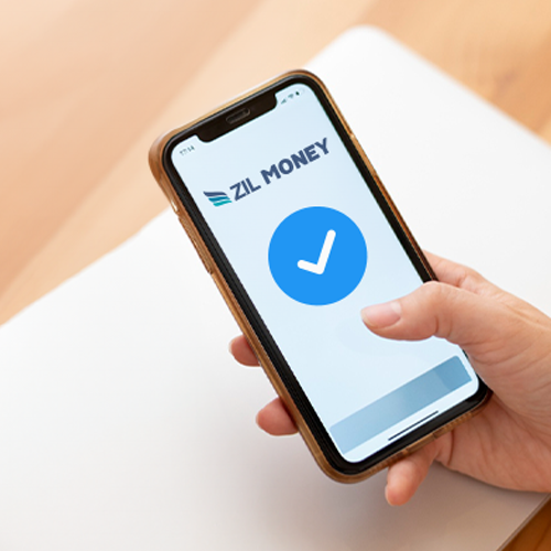 A Person Holding a Smartphone Displaying the Zil Money App Showing Accounts Payable Process.