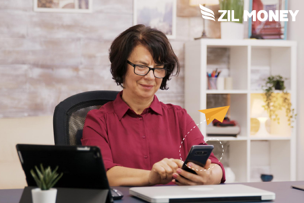 A Woman Makes Checks By Mail Free Using Her Phone.