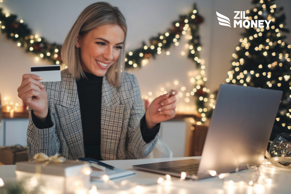 A Women Holding a Credit Card Looking at a Laptop. Credit Card Payment for Business to Celebrate New Year’s Eve