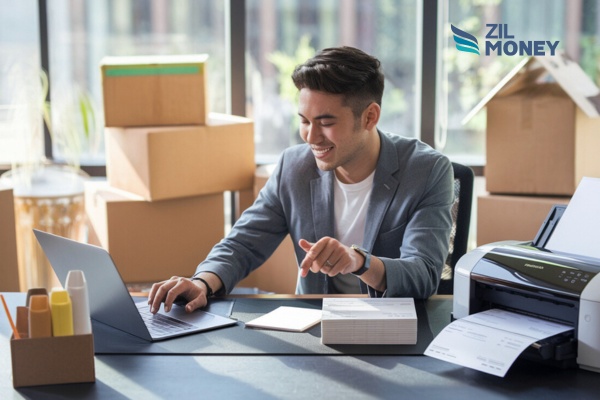 A Man Using a Laptop And a Printer to Create Checks. Vistaprint Checks Alternative – The Smart Way to Print Checks Instantly for Your Moving Service!