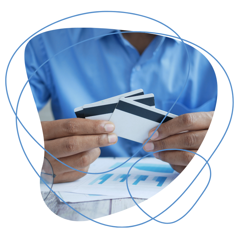 A Person Holding Two Credit Cards. Maintain Cash Flow