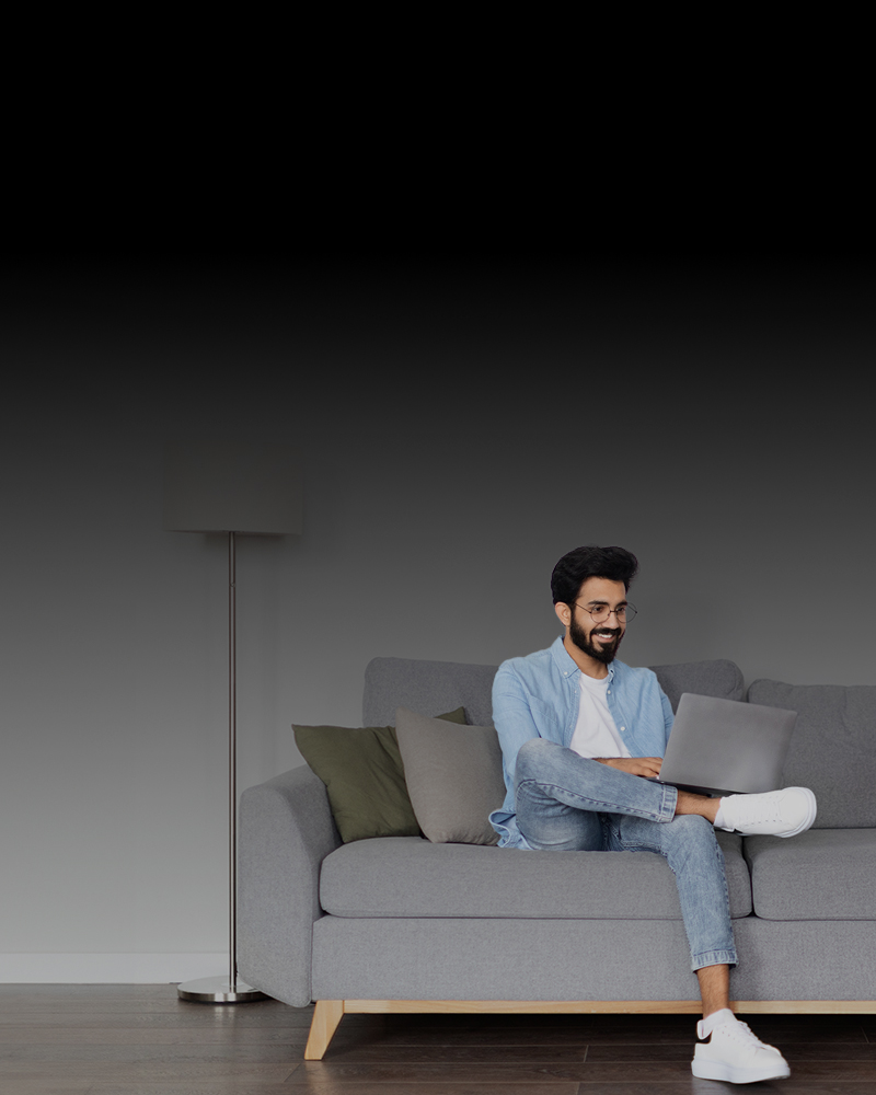 A Man Using A Laptop To Make Check Mailing Effortlessly. Fast, Secure, and Affordable Transfer. Secure, Affordable & Hassle-Free Service