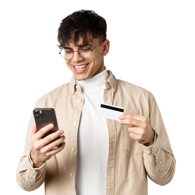 A smiling man with glasses holds a phone and a credit card, showcasing how to easily make credit card payments with convenience.
