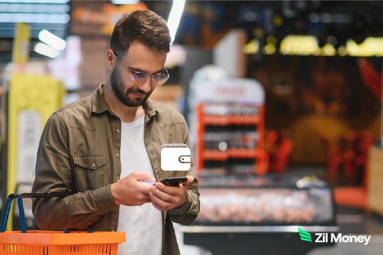 A Man Using A Phone to Make a Digital Wallet Payment for Secure, Fast Payments. Access ACH, Wire & Virtual Card