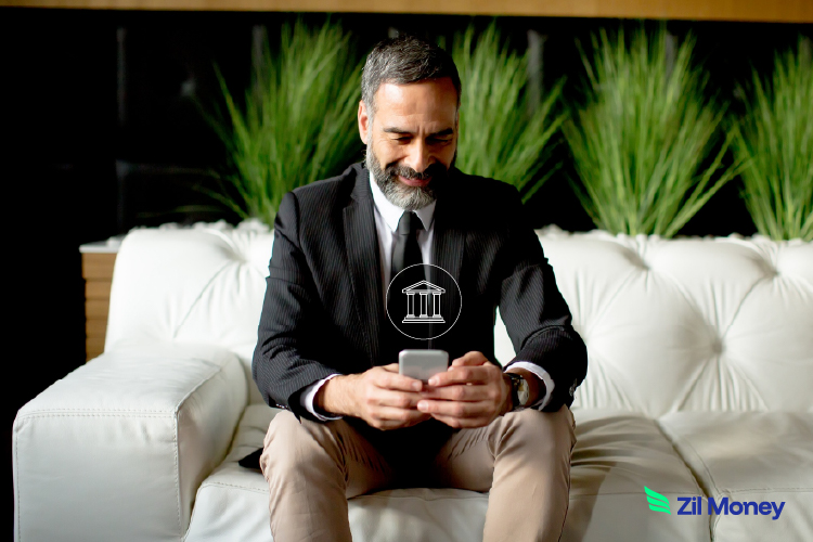 A Businessman Using a Phone to Make a Payment by ACH. Revolutionizing U.S. Business Finance in 2025