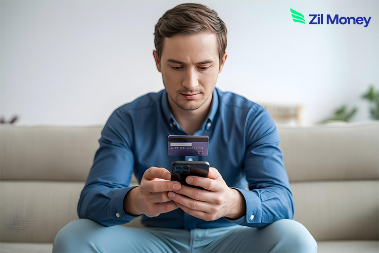 A Man Uses His Phone While Holding a Virtual Card, Showing Secure and Convenient Online Payments.