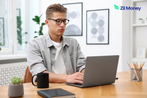 The Unmatched Power of Wire Transfers Speed, Security, and Precision in High-Volume Transactions A professional working on a laptop, showing how Wire Transfers support fast, secure business payments from a modern workspace.