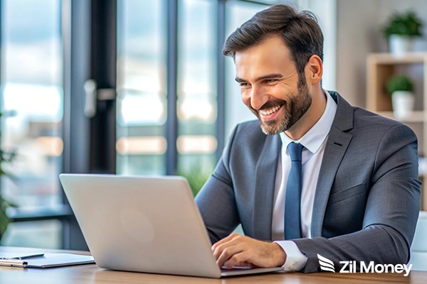 Building Stronger Supplier Networks with Reliable Payment Infrastructure Professional man at a laptop processing wholesale payments to improve business financial efficiency.