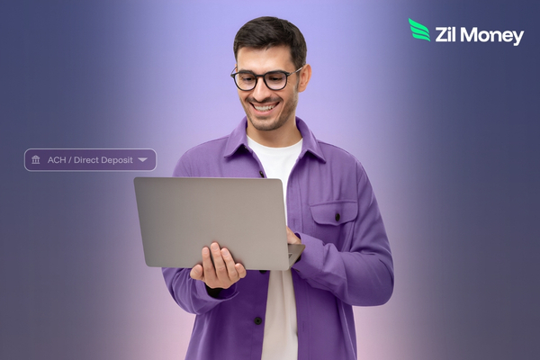 Man in a purple shirt uses a laptop to manage Direct Deposit for efficient business payments.