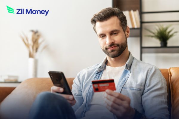 Man using phone and credit card for Rent Payment, showing a convenient and secure way to pay rent