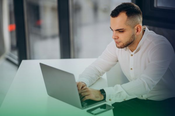 4 Bulk Payments Problems and How to Solve Them A businessman uses a laptop to manage a Bulk Payment, illustrating efficient financial operations.