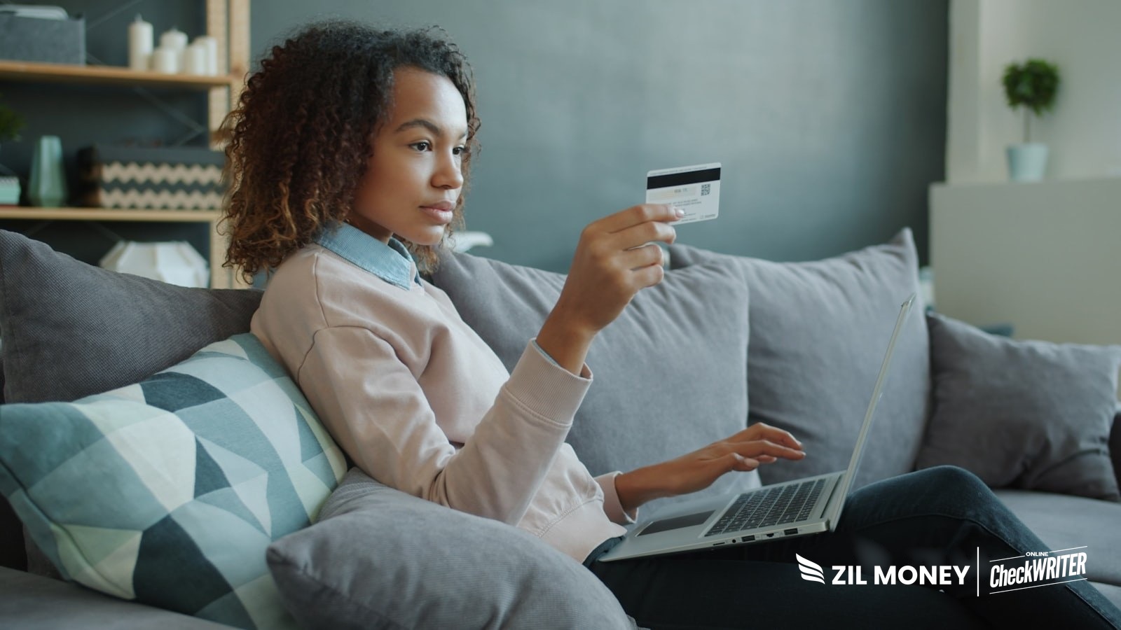 Person using a laptop and a credit card, representing a virtual card for vendor payments with Zil Money