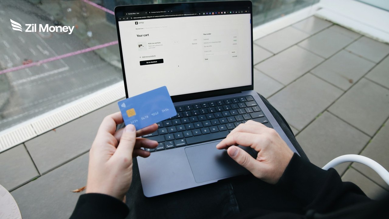 Customer learning how to receive credit card payments by paying with a card at a laptop checkout Customer learning how to receive credit card payments by paying with a card at a laptop checkout