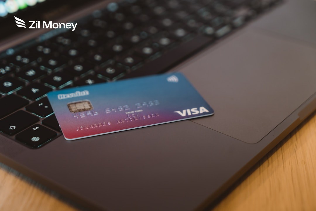 Pay rent using a credit card online A Visa credit card resting on a laptop, used to pay rent online