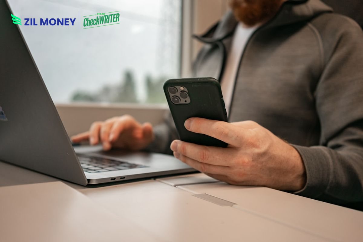 Real time payments for business with Zil Money Real time payments for business, professional managing real-time payments on a phone and laptop