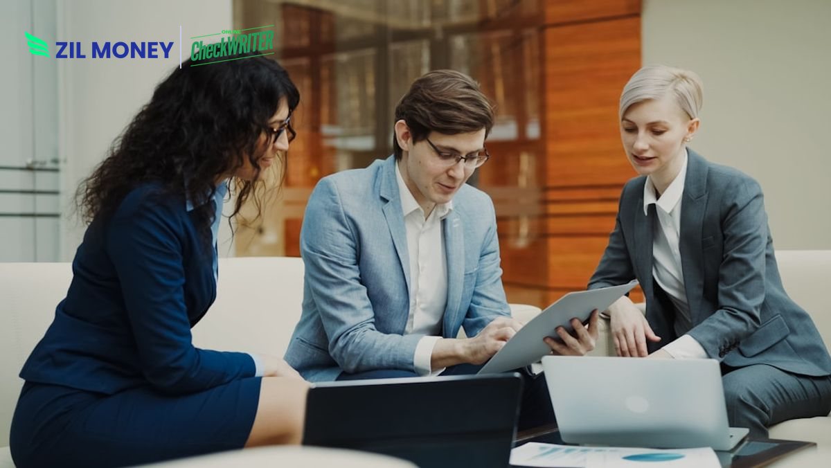 Send a business wire transfer online, finance team reviewing payments on a laptop dashboard
