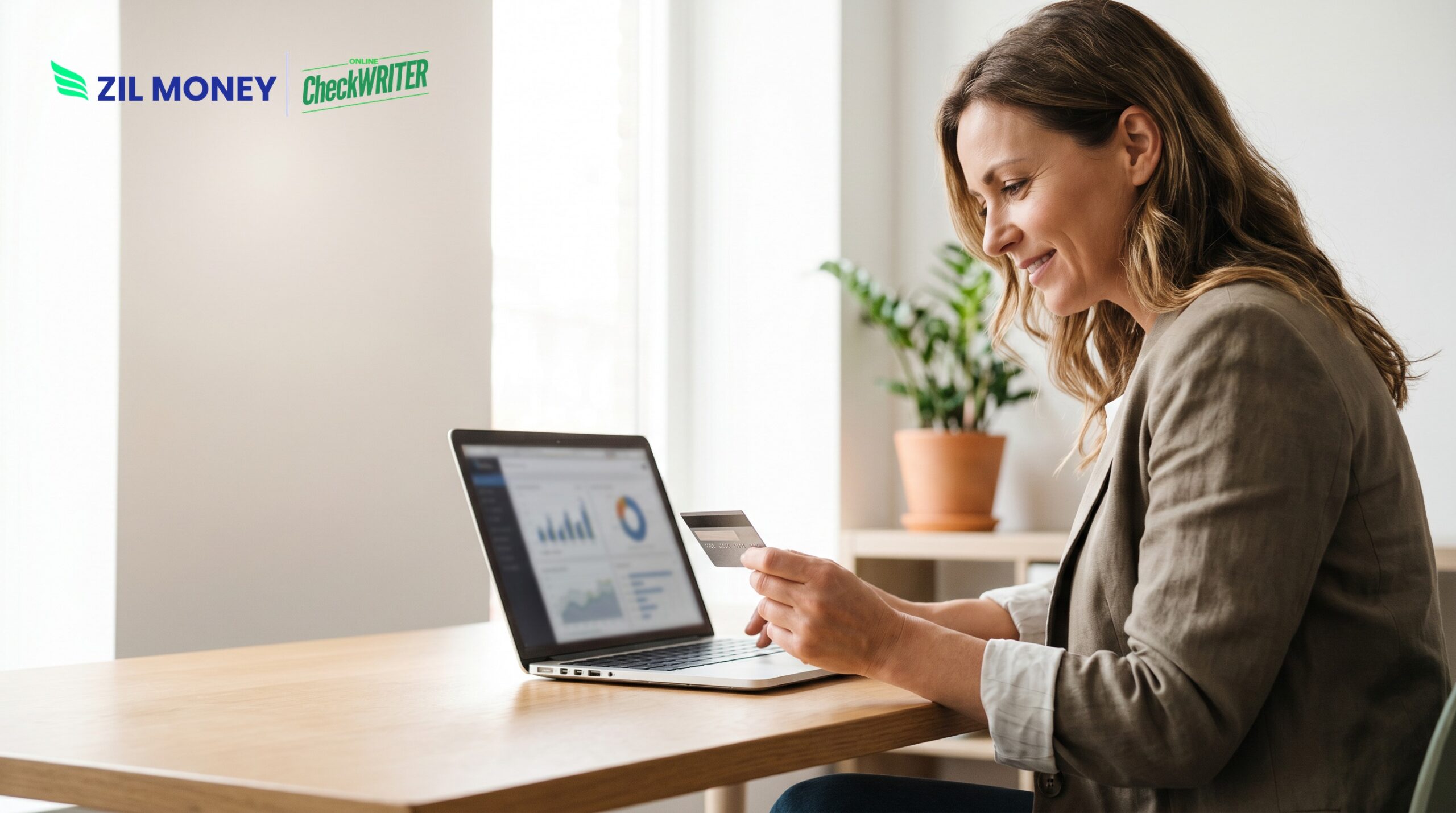 Business owner using a laptop and credit card to pay payroll with a credit card
