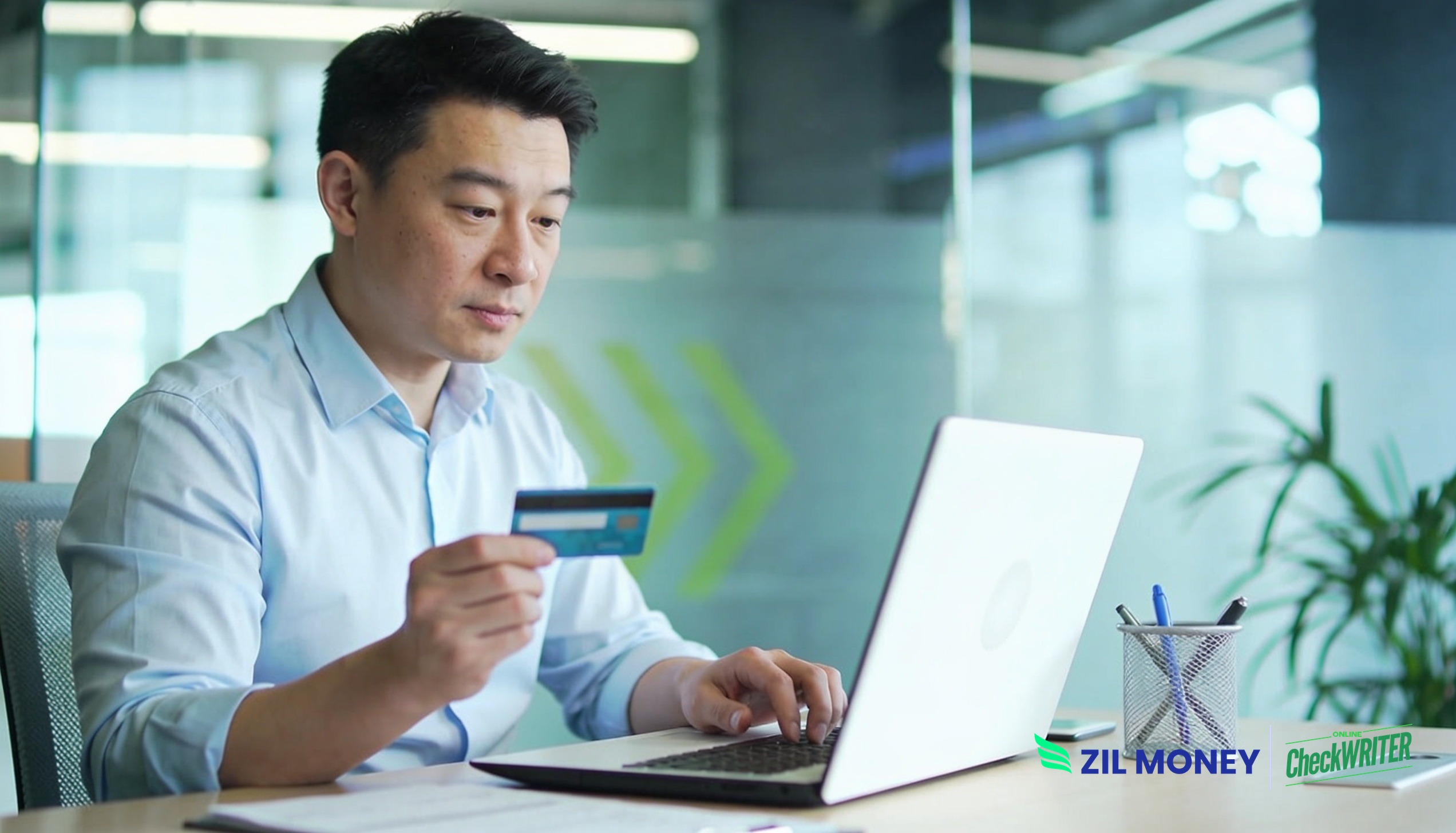make-an-ach-payment-with-a-credit-card-zm Business owner making an ACH payment with a credit card on a laptop